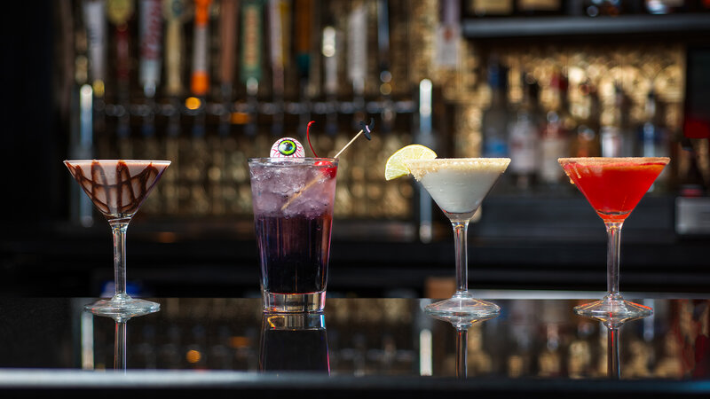 Four cocktails on top of bar